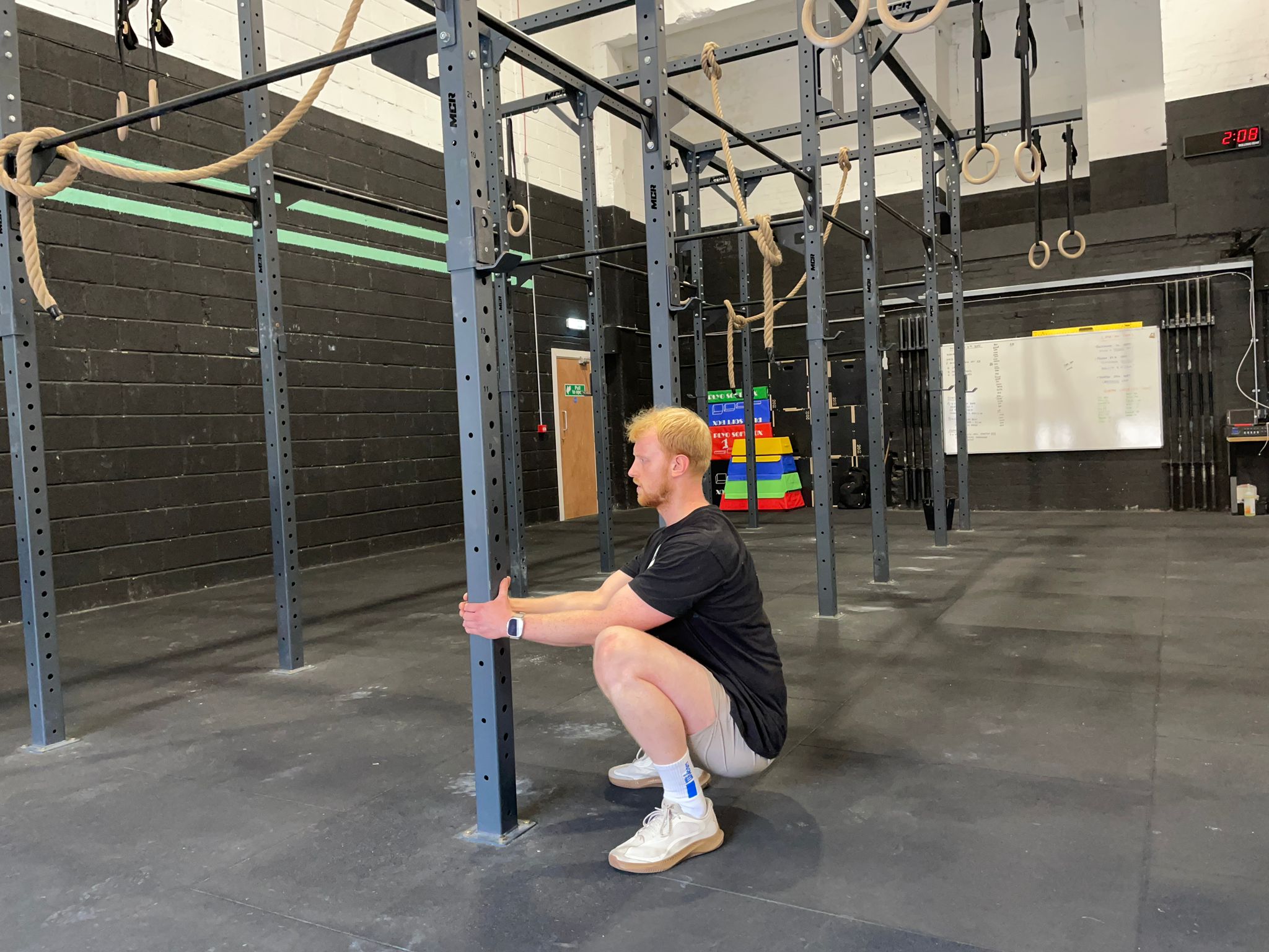 Exercise writer Harry Bullmore holding the squat position